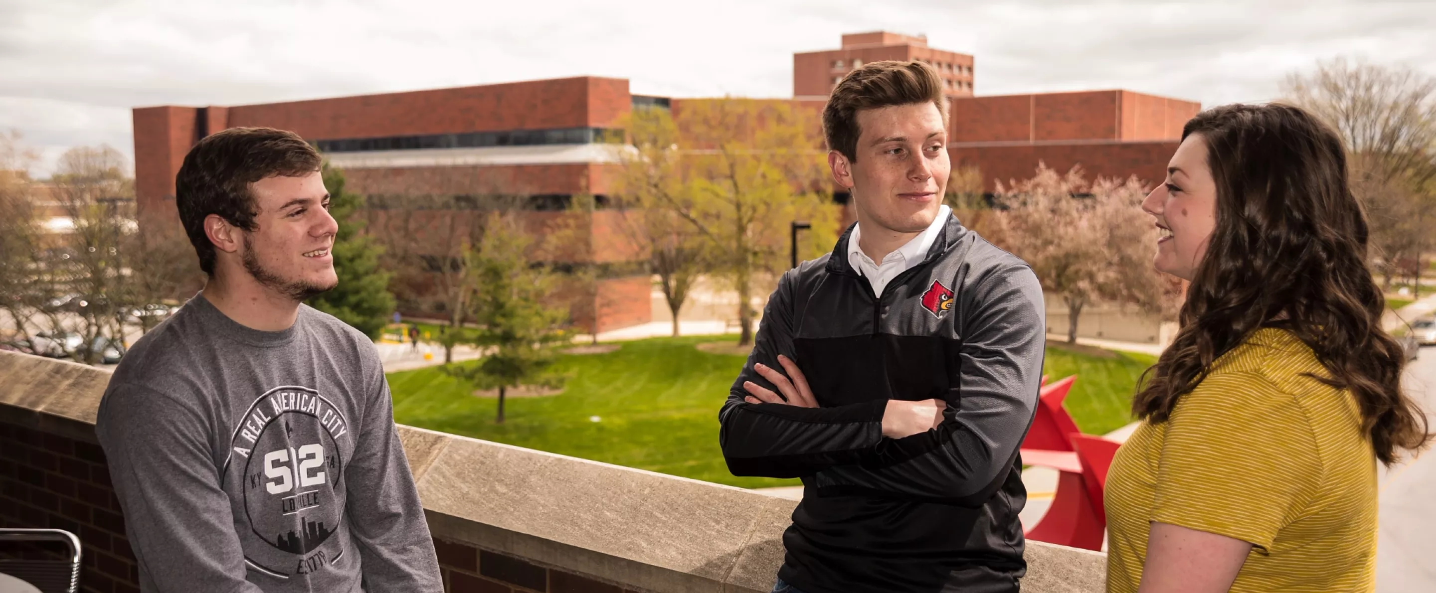 Students have conversation outside the College of Business