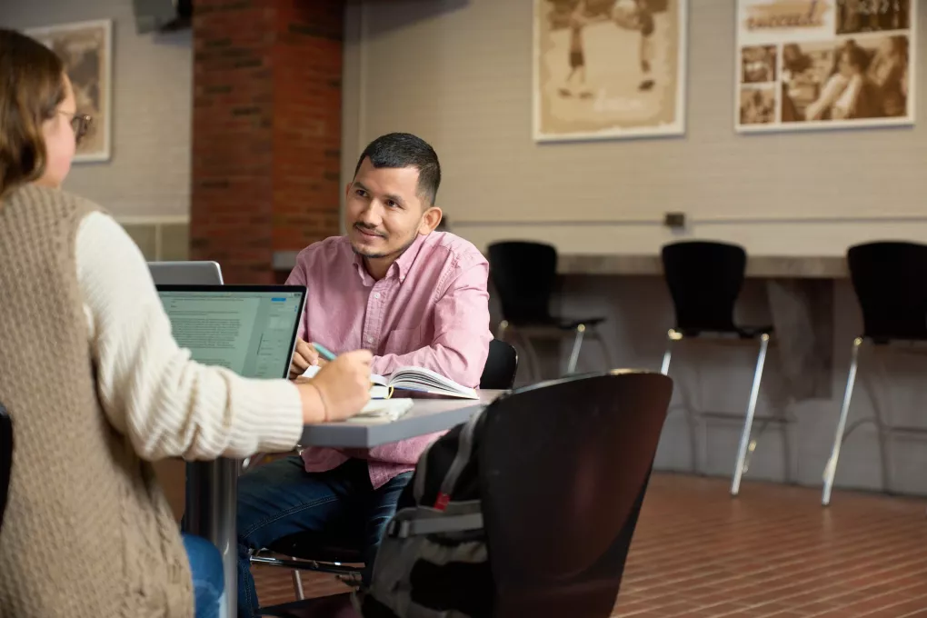 Students talking and studying.