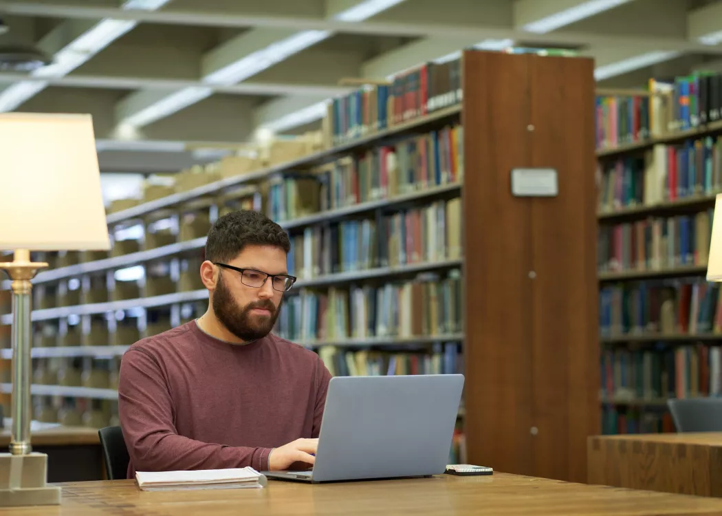 Student studies in the library.